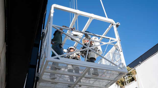 NASA astronauts Nicole Mann and Doug “Wheels” Wheelock testing out the mockup elevator.